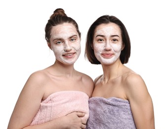 Photo of Spa day. Beautiful women with face masks wrapped in towels on white background