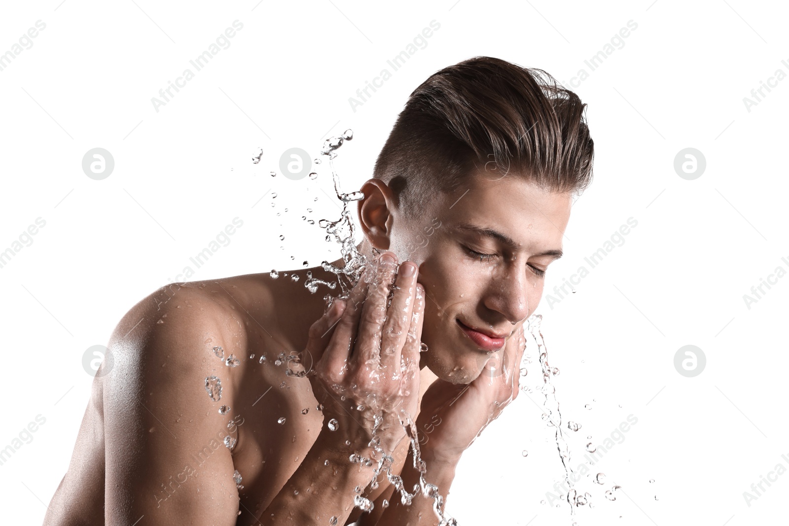 Photo of Handsome man washing his face on white background