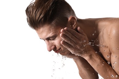 Photo of Handsome man washing his face on white background