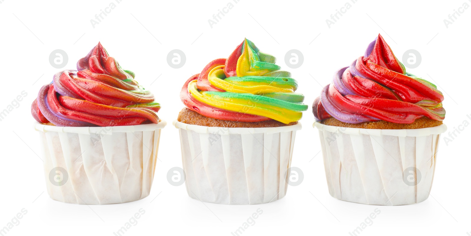 Photo of Delicious cupcakes with colorful cream isolated on white