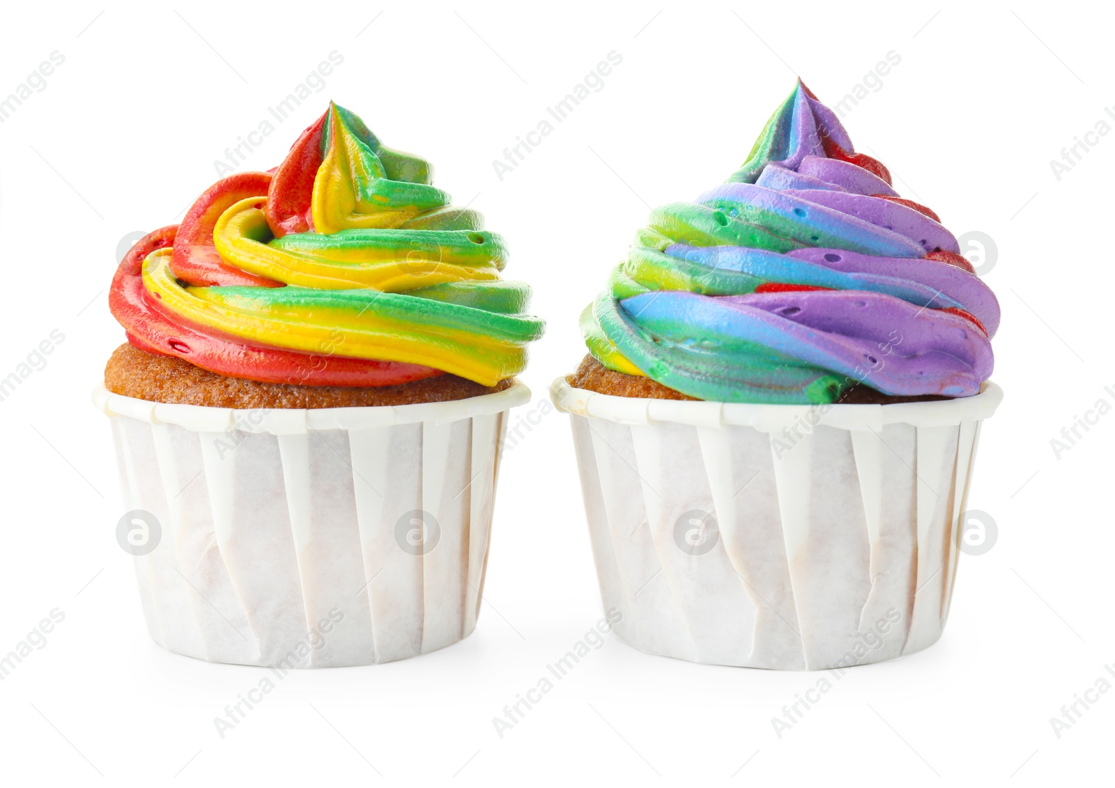 Photo of Delicious cupcakes with colorful cream isolated on white