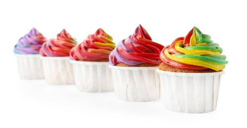 Photo of Delicious cupcakes with colorful cream isolated on white