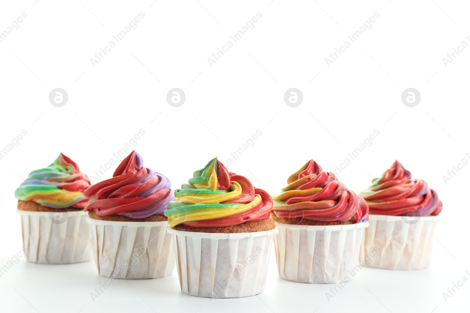 Photo of Delicious cupcakes with colorful cream on white background, closeup