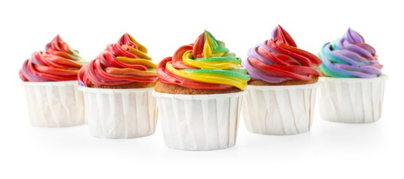 Photo of Delicious cupcakes with colorful cream isolated on white