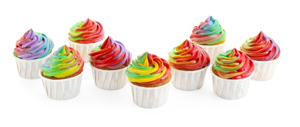 Photo of Delicious cupcakes with colorful cream isolated on white