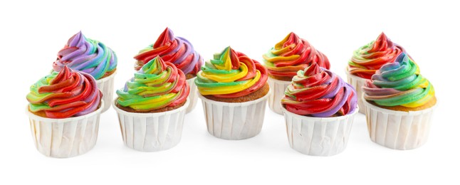 Photo of Delicious cupcakes with colorful cream isolated on white