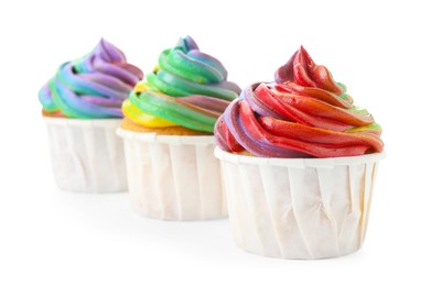 Photo of Delicious cupcakes with colorful cream isolated on white