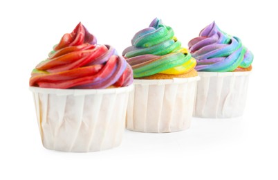 Photo of Delicious cupcakes with colorful cream isolated on white