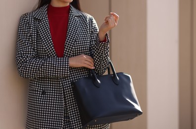 Photo of Businesswoman in stylish suit outdoors, closeup. Space for text