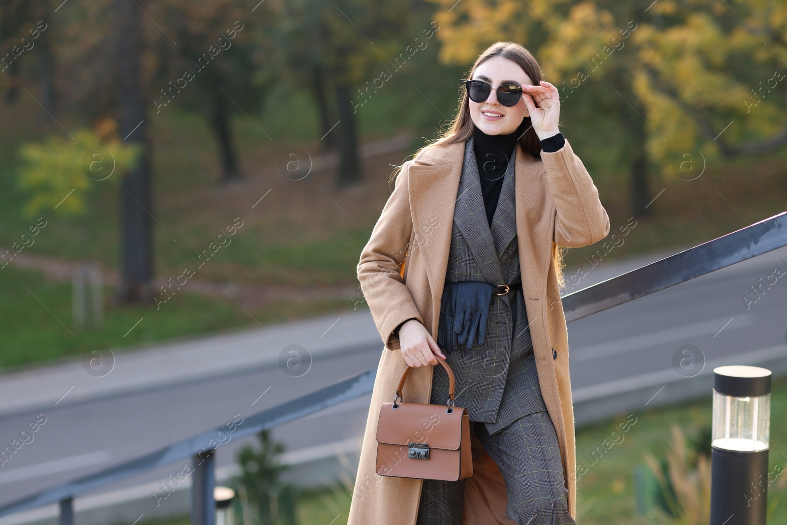 Photo of Beautiful woman in stylish suit outdoors. Space for text