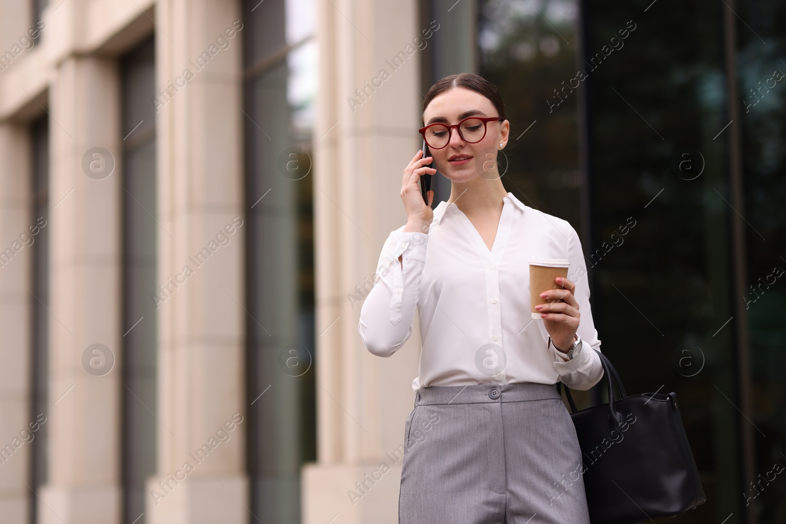 Photo of Woman in stylish outfit talking on phone outdoors. Space for text