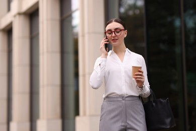 Photo of Woman in stylish outfit talking on phone outdoors. Space for text