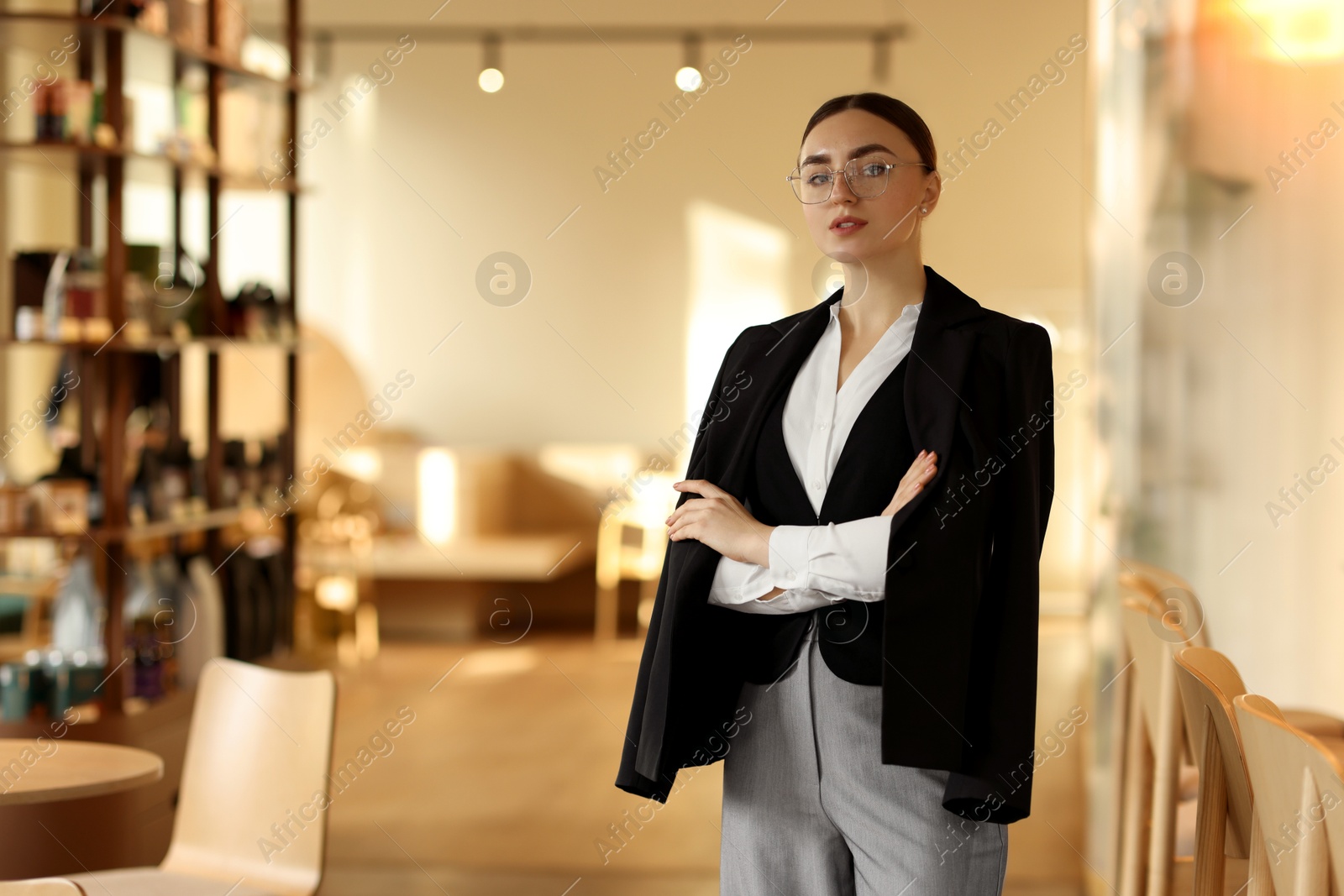 Photo of Beautiful woman in stylish formal suit indoors. Space for text