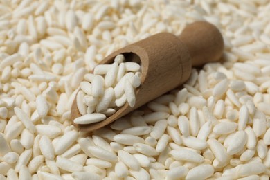 Photo of Scoop with puffed rice as background, closeup