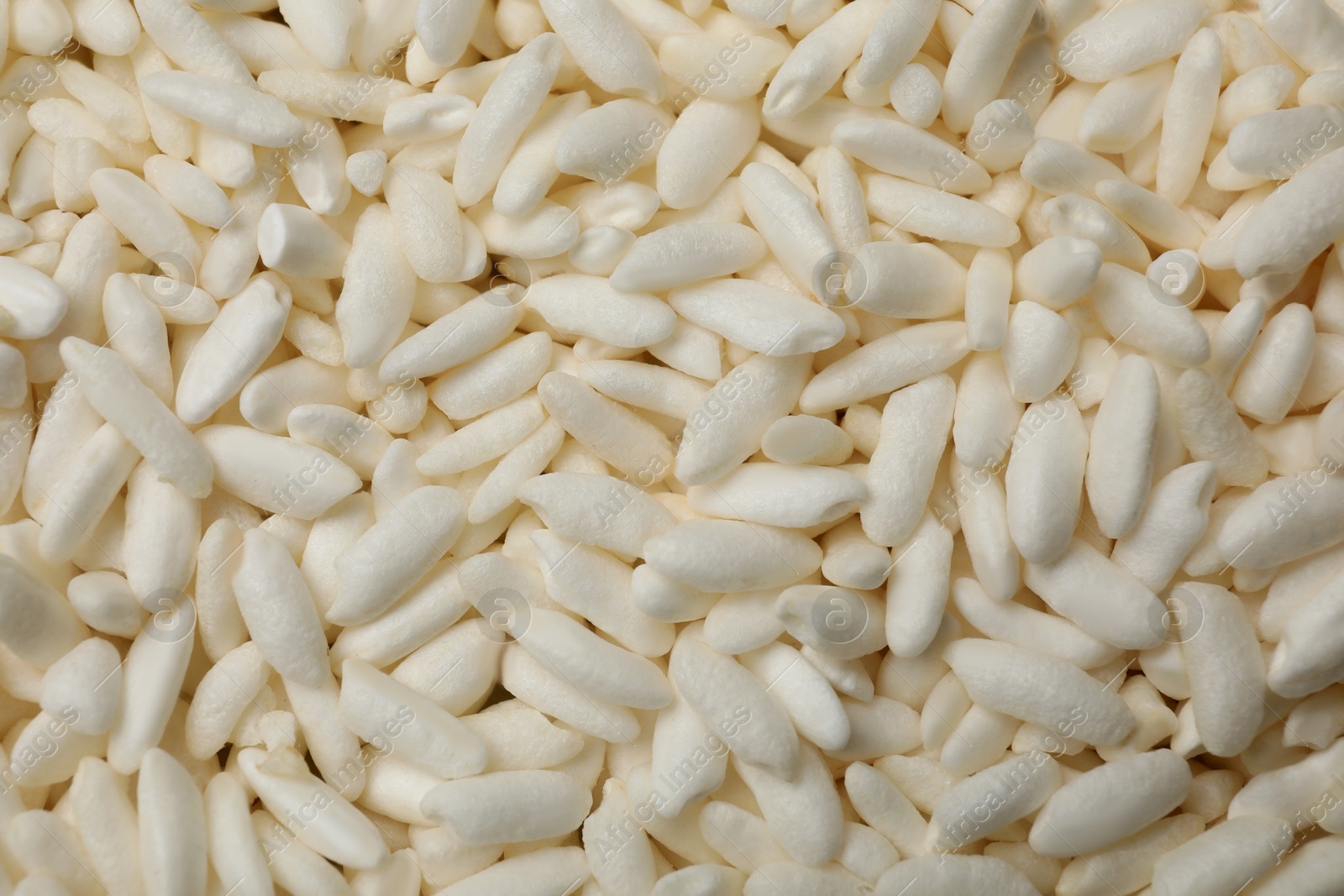 Photo of Wholegrain puffed rice as background, closeup view