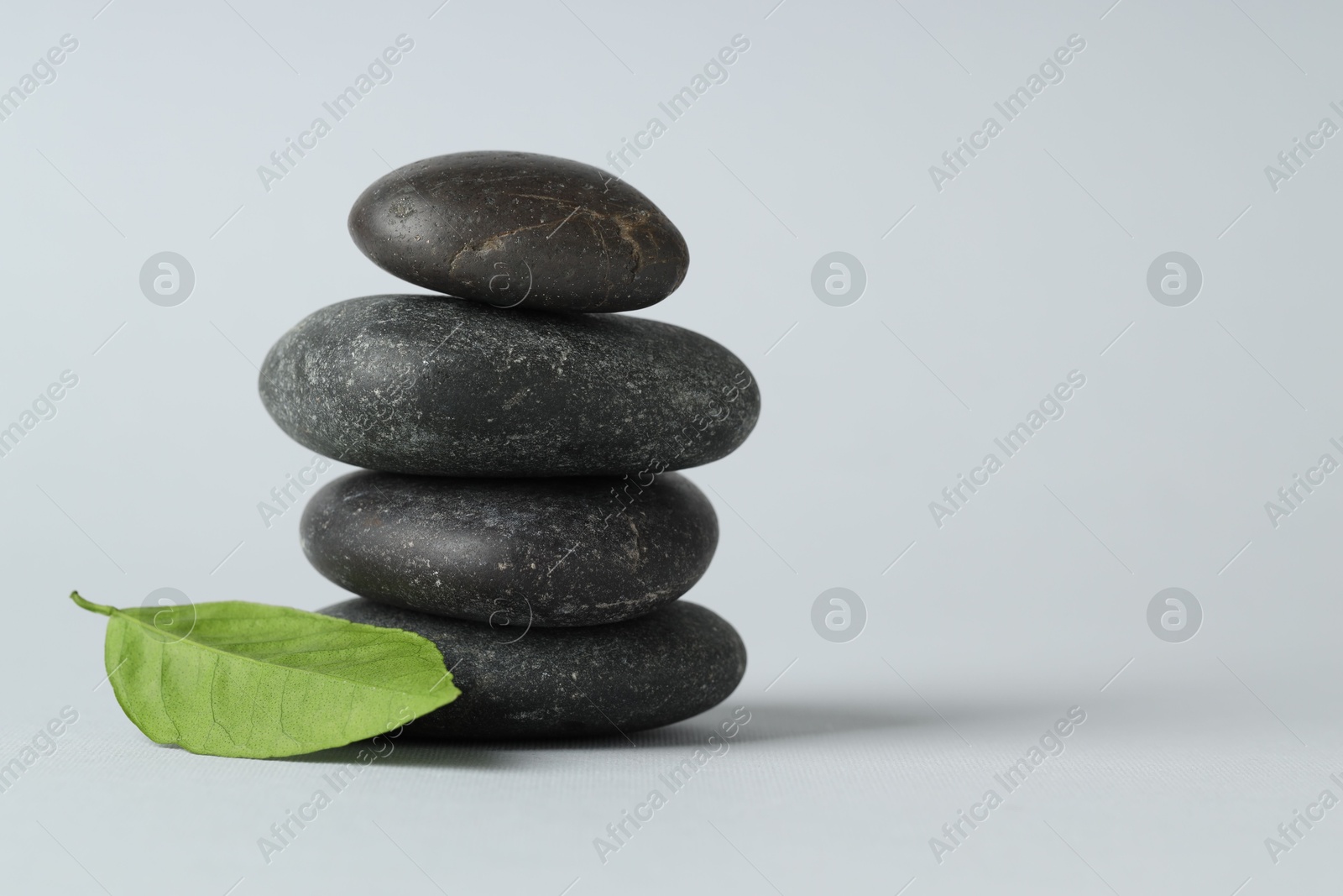 Photo of Stack of rocks on gray background, space for text. Harmony and life balance