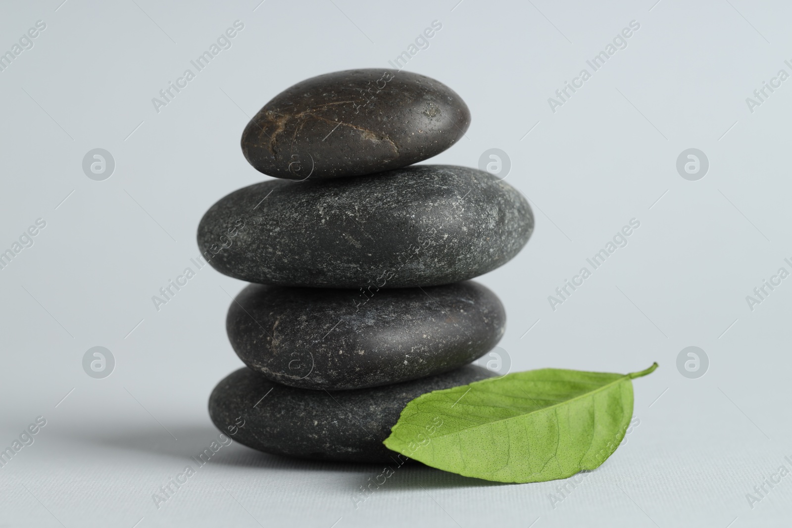 Photo of Stack of rocks on gray background. Harmony and life balance