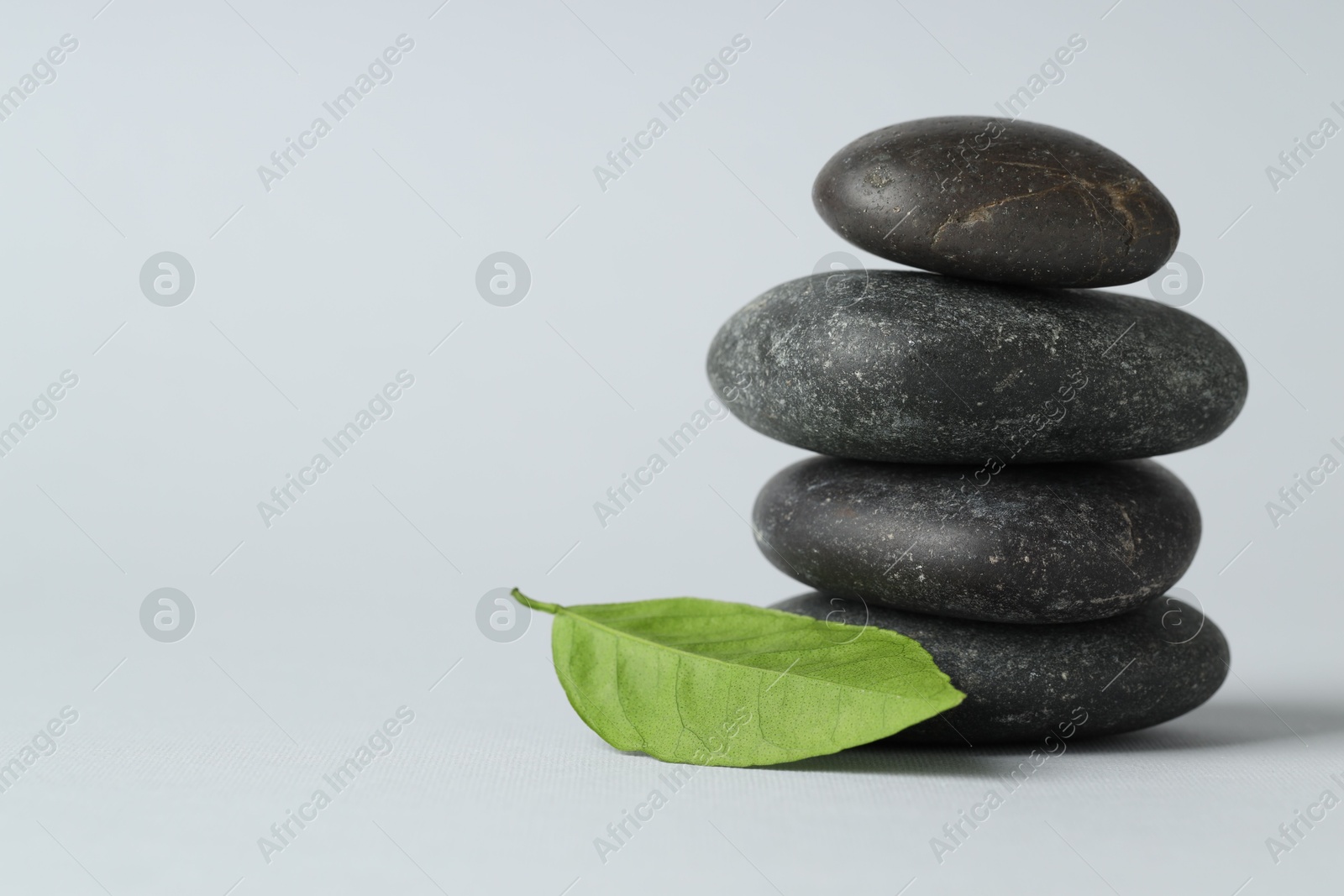 Photo of Stack of rocks on gray background, space for text. Harmony and life balance