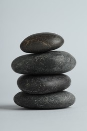 Photo of Stack of rocks on gray background. Harmony and life balance