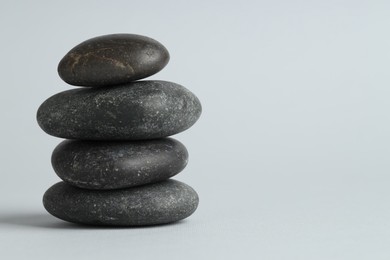 Photo of Stack of rocks on gray background, space for text. Harmony and life balance