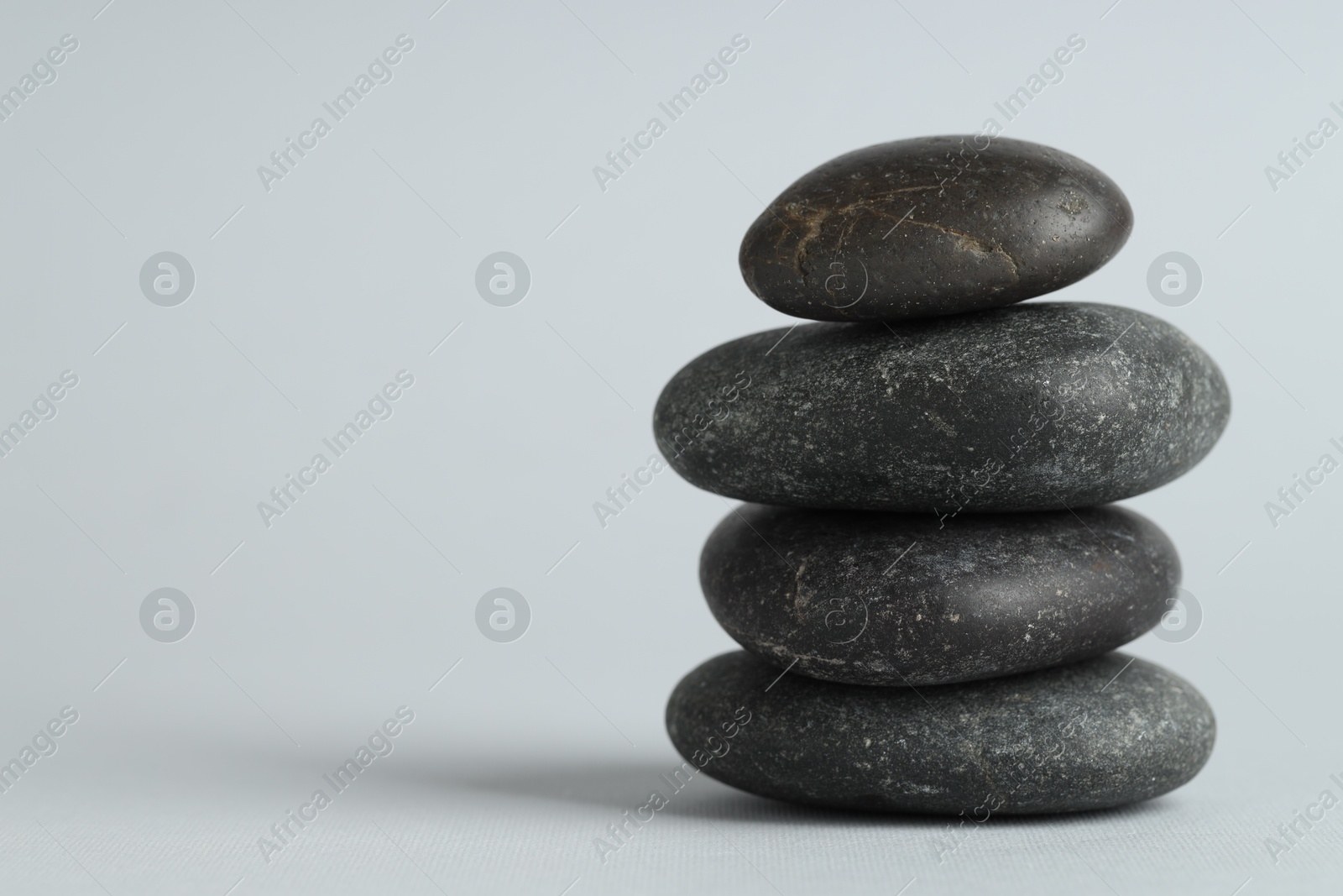 Photo of Stack of rocks on gray background, space for text. Harmony and life balance