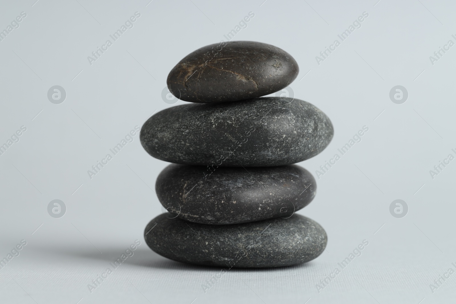 Photo of Stack of rocks on gray background. Harmony and life balance