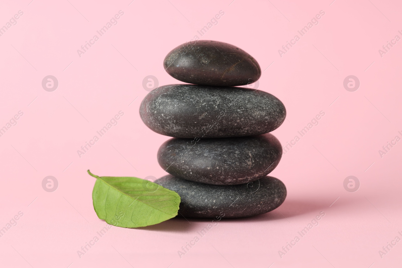 Photo of Stack of rocks on pink background. Harmony and life balance