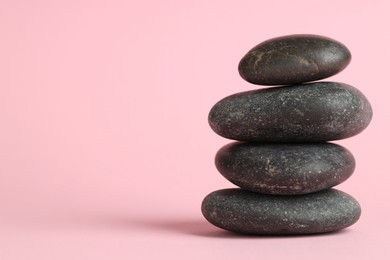 Photo of Stack of rocks on pink background, space for text. Harmony and life balance