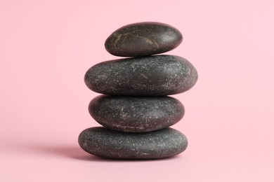 Photo of Stack of rocks on pink background. Harmony and life balance