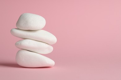 Photo of Stack of rocks on pink background, space for text. Harmony and life balance