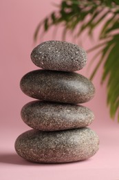 Photo of Stack of rocks on pink background. Harmony and life balance