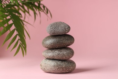 Photo of Stack of rocks on pink background. Harmony and life balance