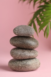 Photo of Stack of rocks on pink background. Harmony and life balance