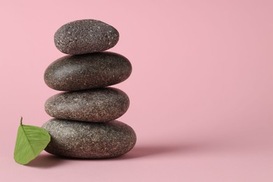 Photo of Stack of rocks on pink background, space for text. Harmony and life balance