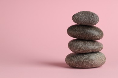 Photo of Stack of rocks on pink background. Harmony and life balance