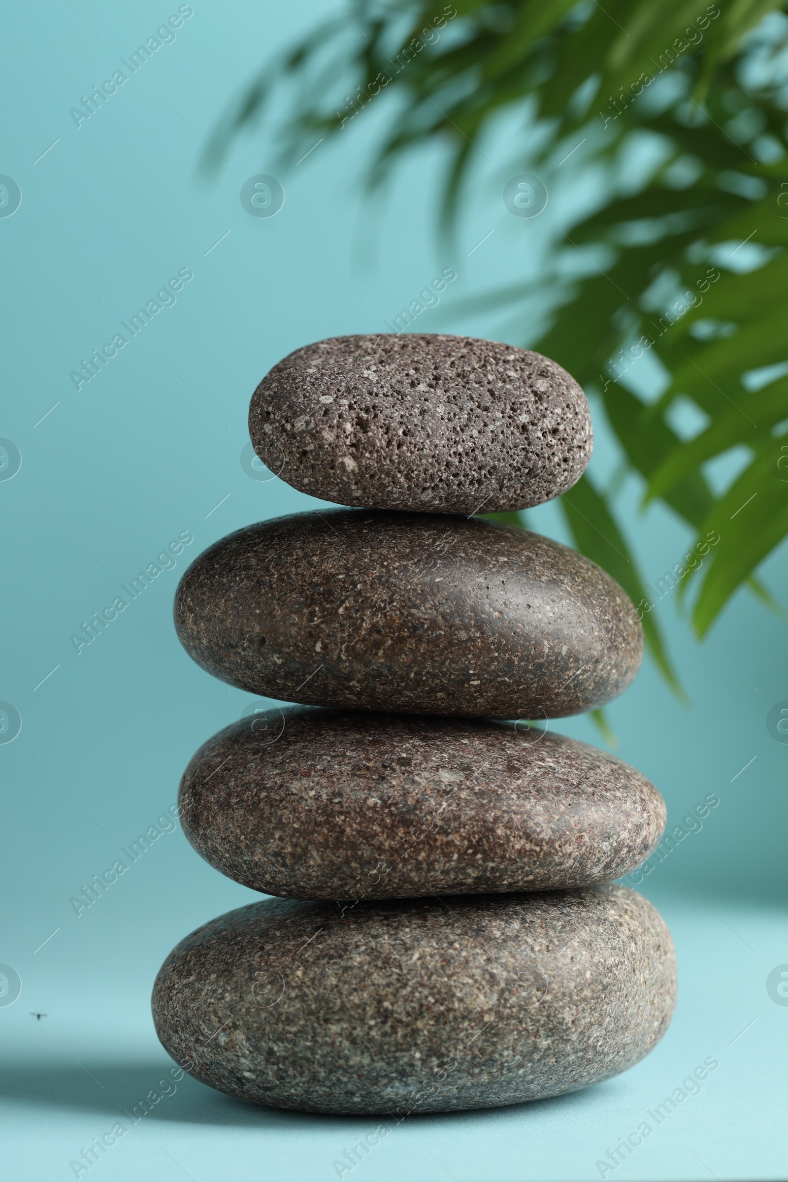 Photo of Stack of rocks on light blue background. Harmony and life balance