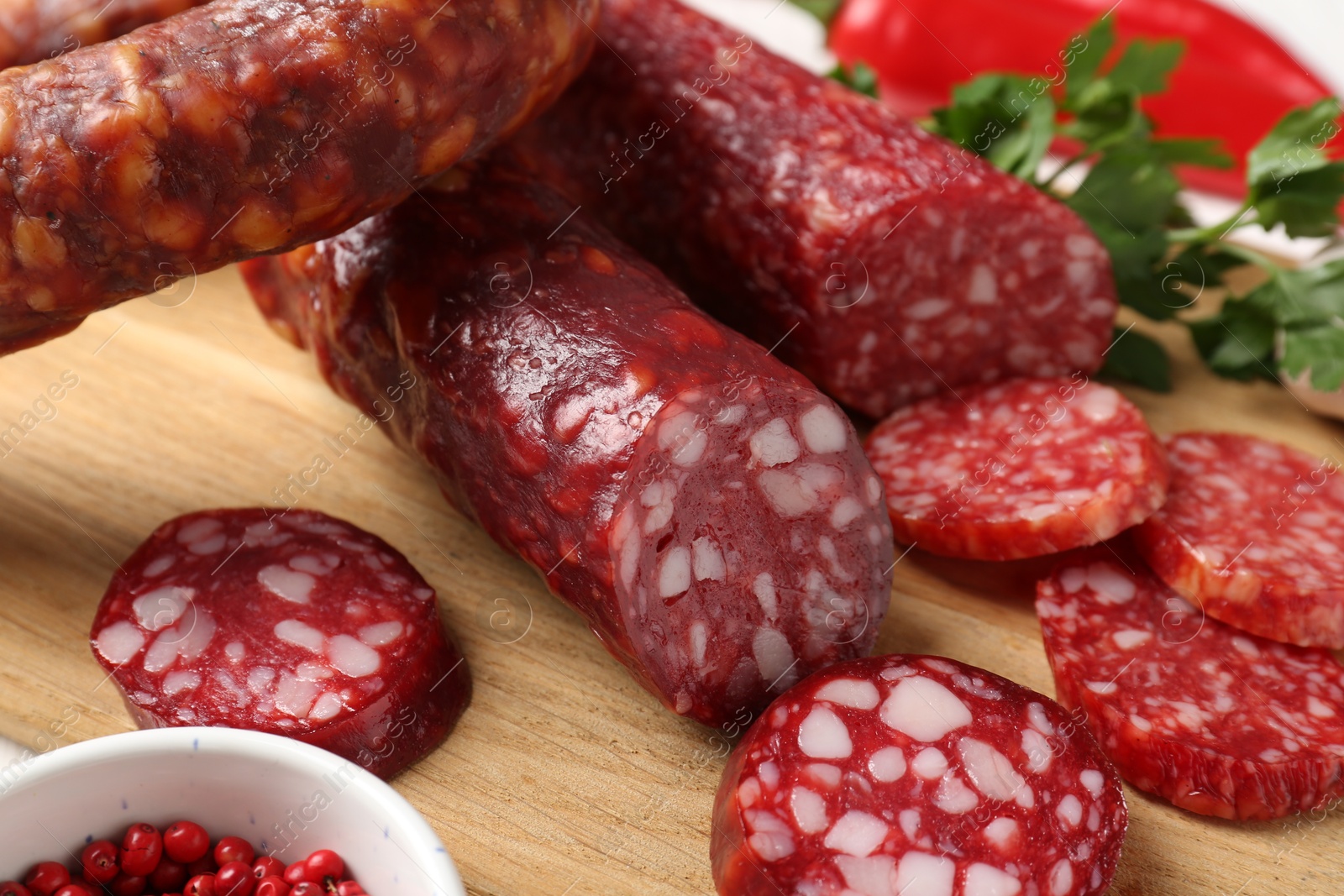 Photo of Different smoked sausages and spices on table, closeup