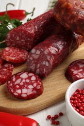 Photo of Different smoked sausages and spices on table, closeup