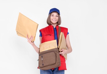 Photo of Happy postwoman with bag and envelopes on white background