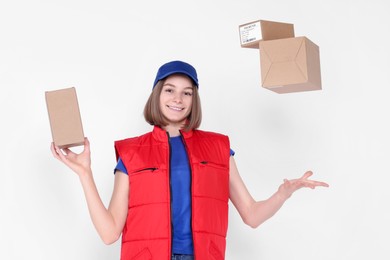 Photo of Happy postwoman with parcels on white background