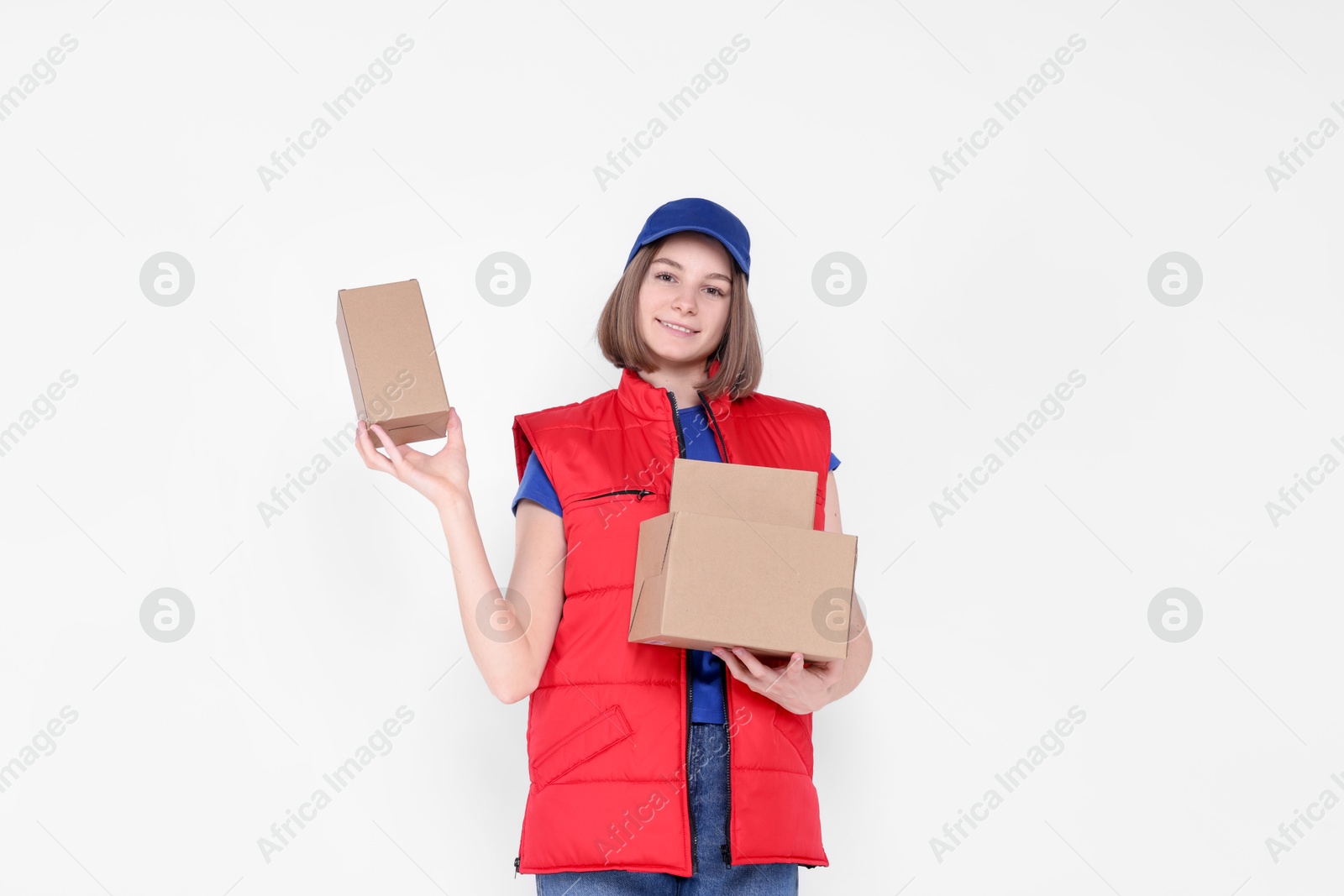 Photo of Happy postwoman with parcels on white background