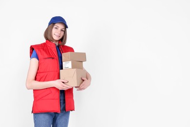 Photo of Happy postwoman with parcels on white background. Space for text