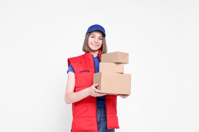 Photo of Happy postwoman with parcels on white background