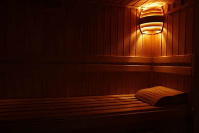 Photo of View of empty wooden sauna with bench