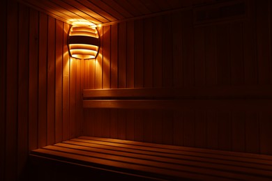 Photo of View of empty wooden sauna with bench