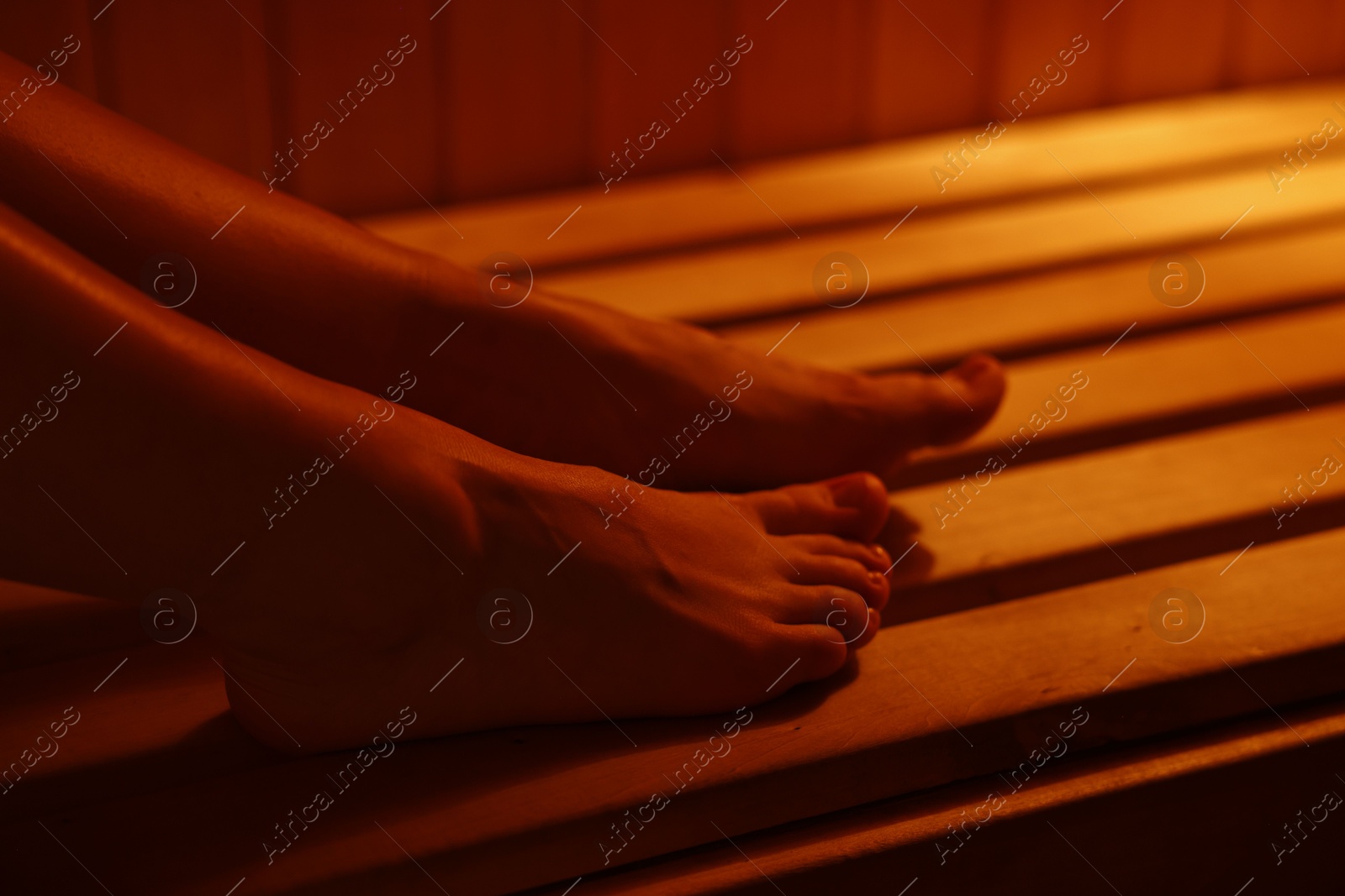 Photo of Young woman relaxing in hot sauna, closeup