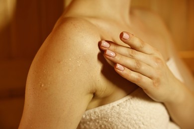 Photo of Young woman relaxing in hot sauna, closeup