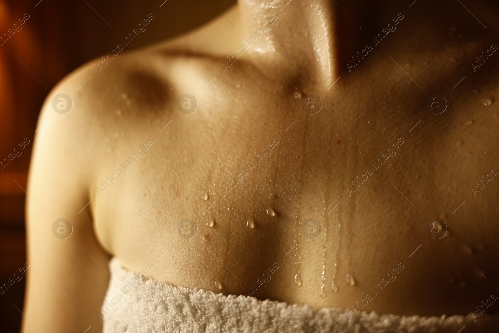 Photo of Young woman relaxing in hot sauna, closeup