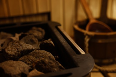 Photo of Stove with hot rocks in sauna, closeup