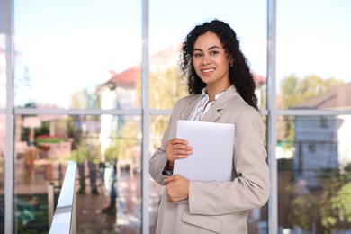 Photo of Portrait of young woman with laptop wearing stylish suit indoors